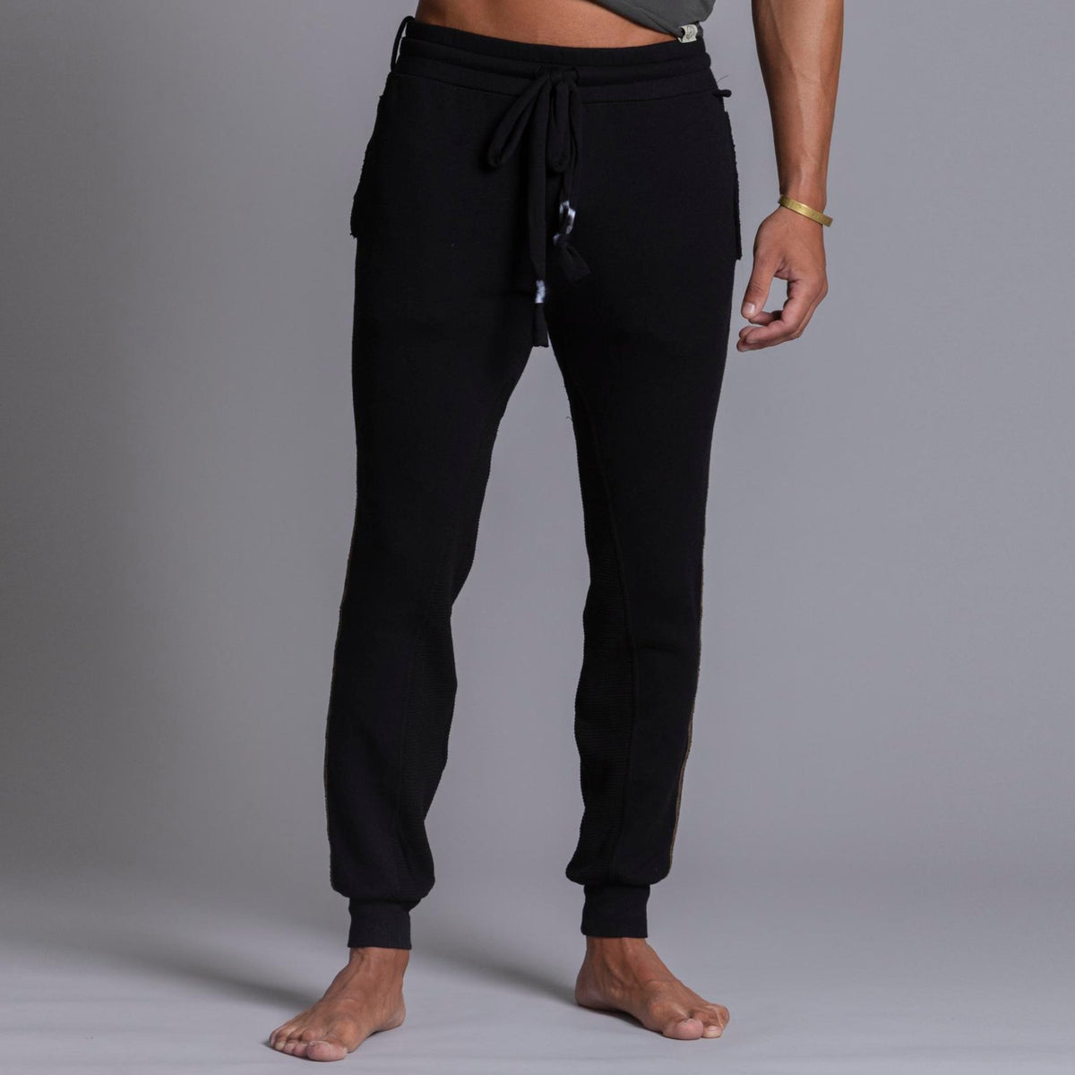 A man modeling black colored jogger pants