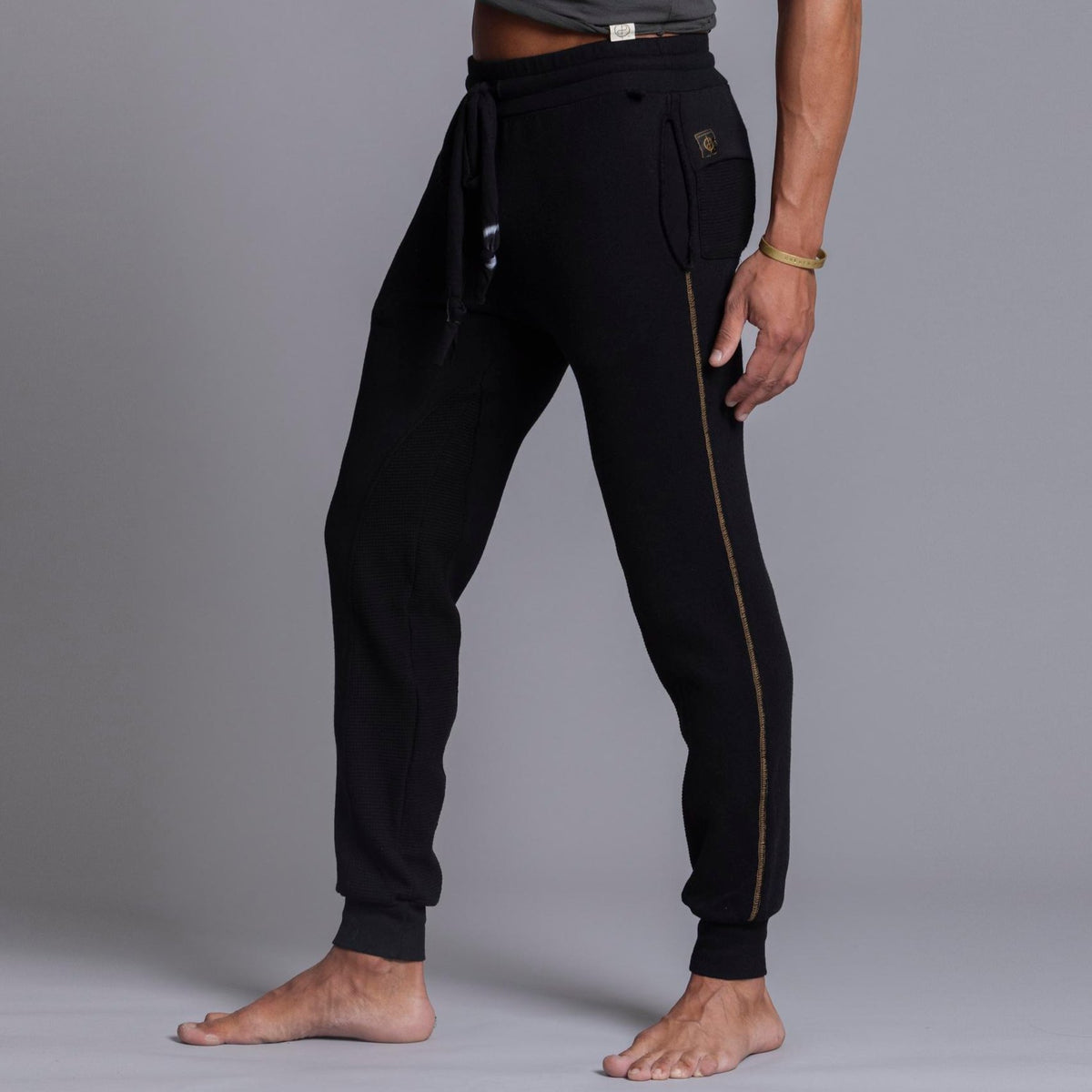 A man modeling black colored jogger pants