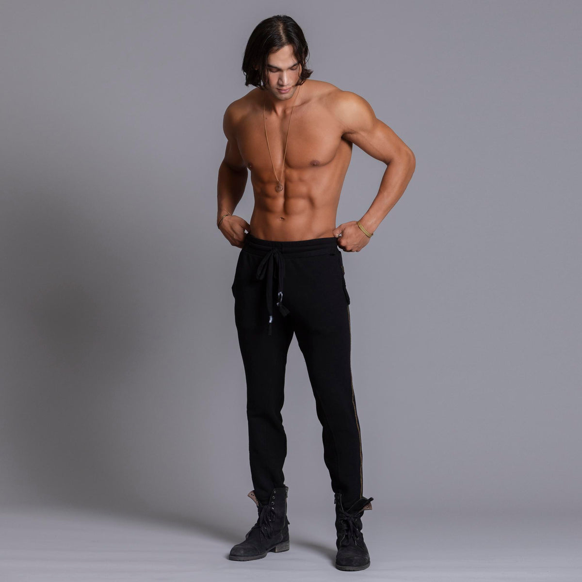 A man modeling black colored jogger pants