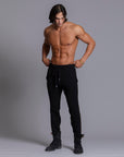 A man modeling black colored jogger pants