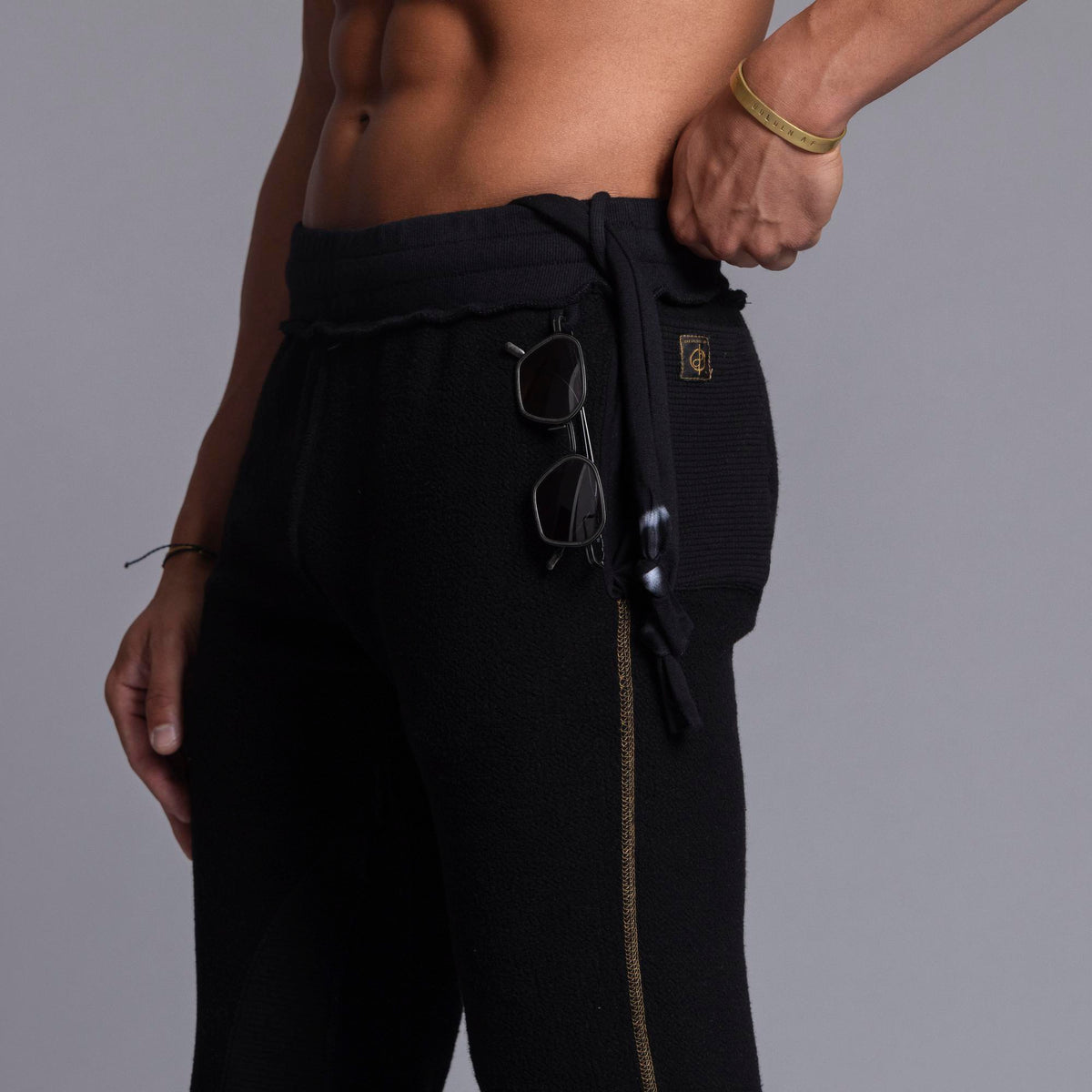 A man modeling black colored jogger pants