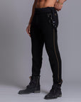 A man modeling black colored jogger pants