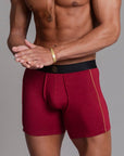 A man modeling the One Golden Thread Unders in Wine Red
