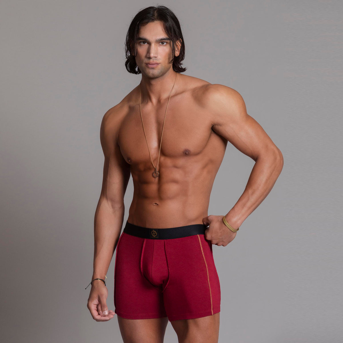 A man modeling the One Golden Thread Unders in Wine Red