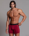 A man modeling the One Golden Thread Unders in Wine Red