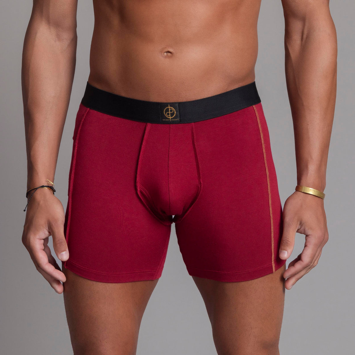 A man modeling the One Golden Thread Unders in Wine Red