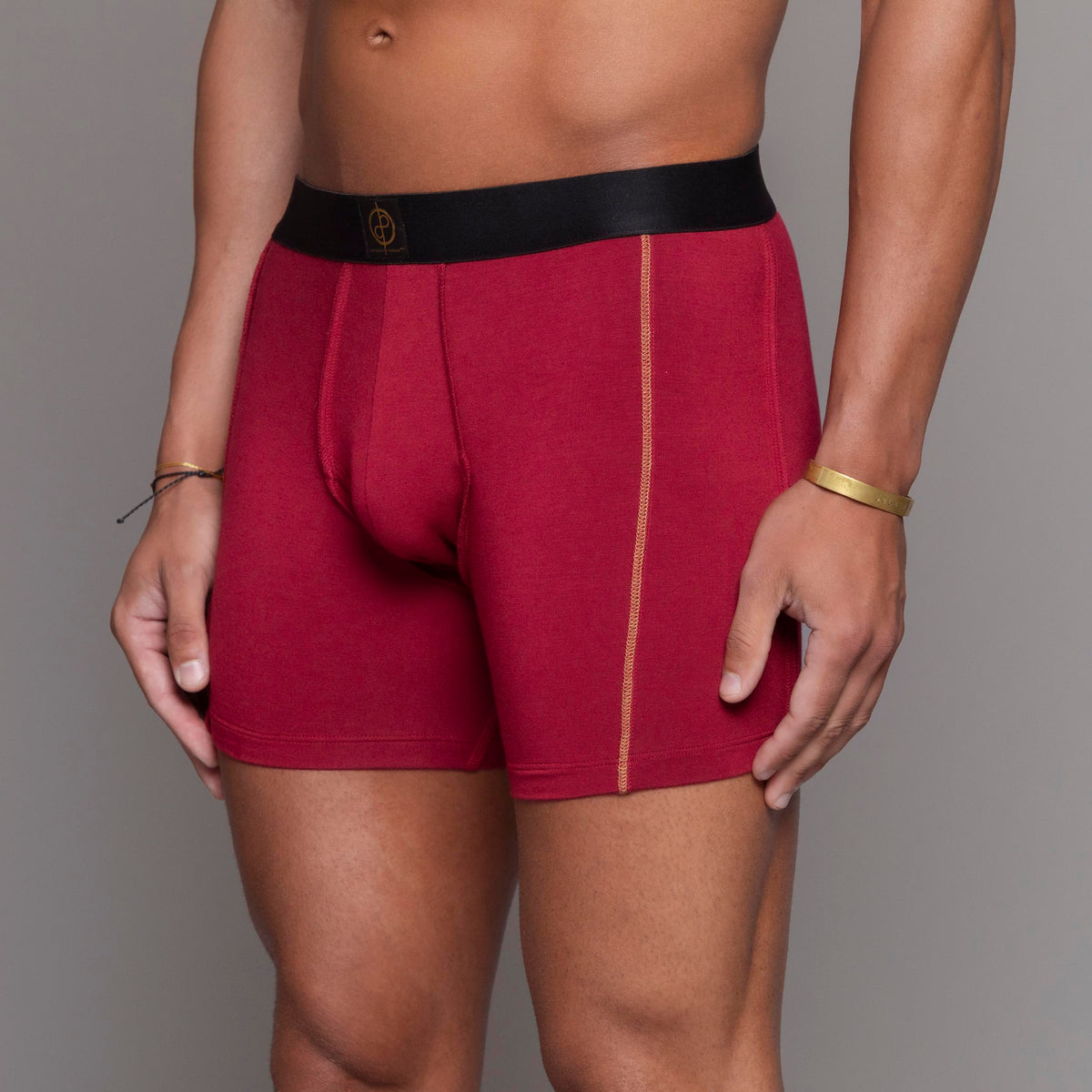 A man modeling the One Golden Thread Unders in Wine Red