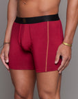 A man modeling the One Golden Thread Unders in Wine Red
