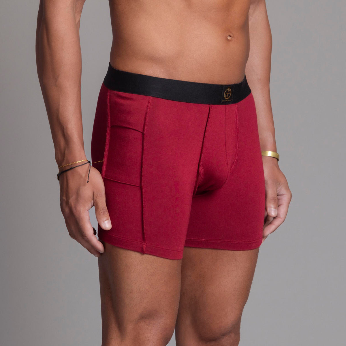 A man modeling the One Golden Thread Unders in Wine Red
