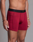 A man modeling the One Golden Thread Unders in Wine Red