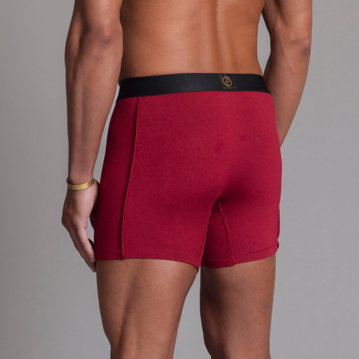 A man modeling the One Golden Thread Unders in Wine Red