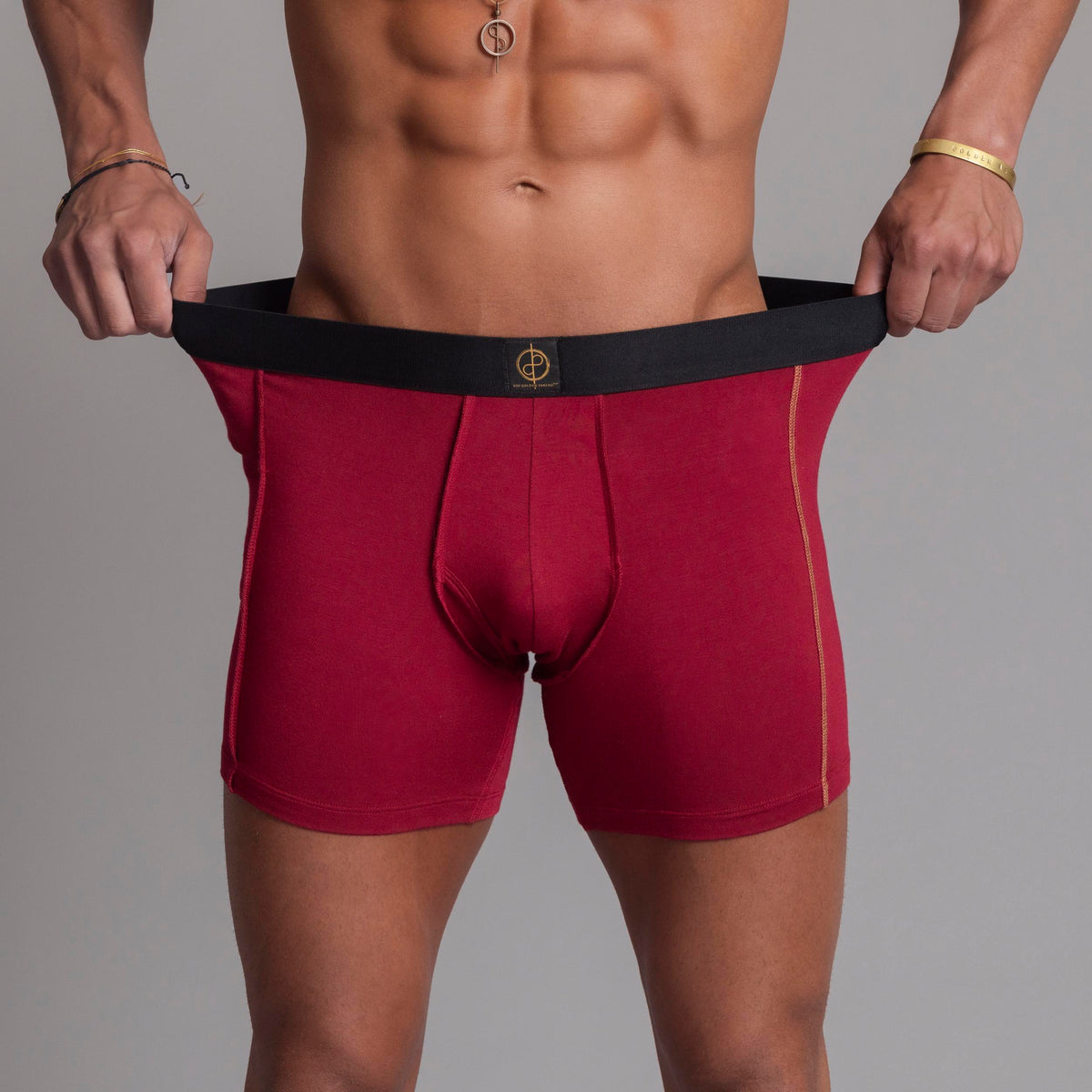 A man modeling the One Golden Thread Unders in Wine Red
