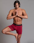 A man modeling the One Golden Thread Unders in Wine Red