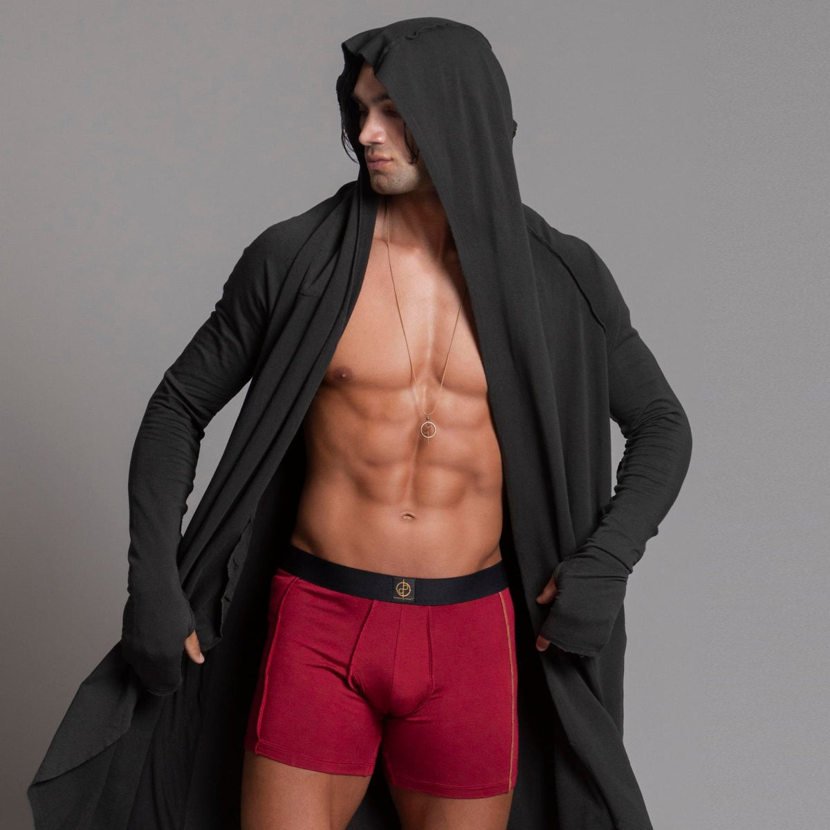 A man modeling the One Golden Thread Unders in Wine Red