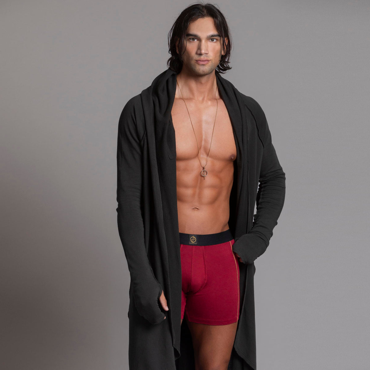 A man modeling the One Golden Thread Unders in Wine Red