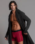 A man modeling the One Golden Thread Unders in Wine Red
