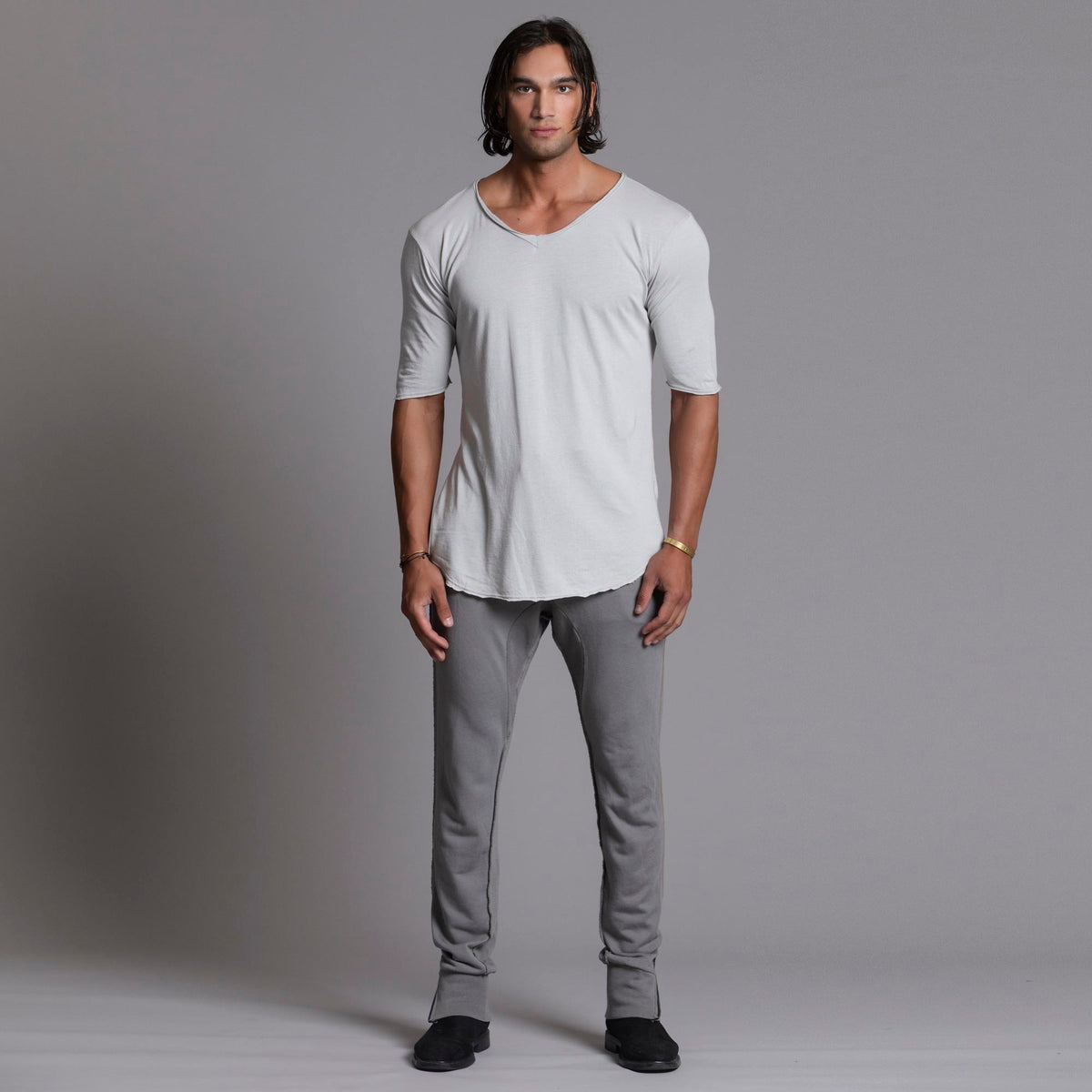 Man modeling the milano pant in deep clay gray