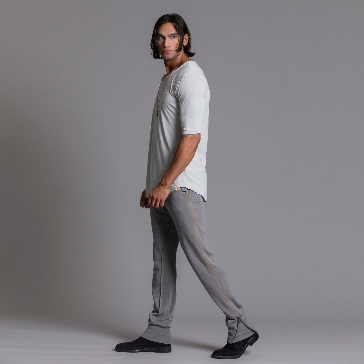 Man modeling the milano pant in deep clay gray