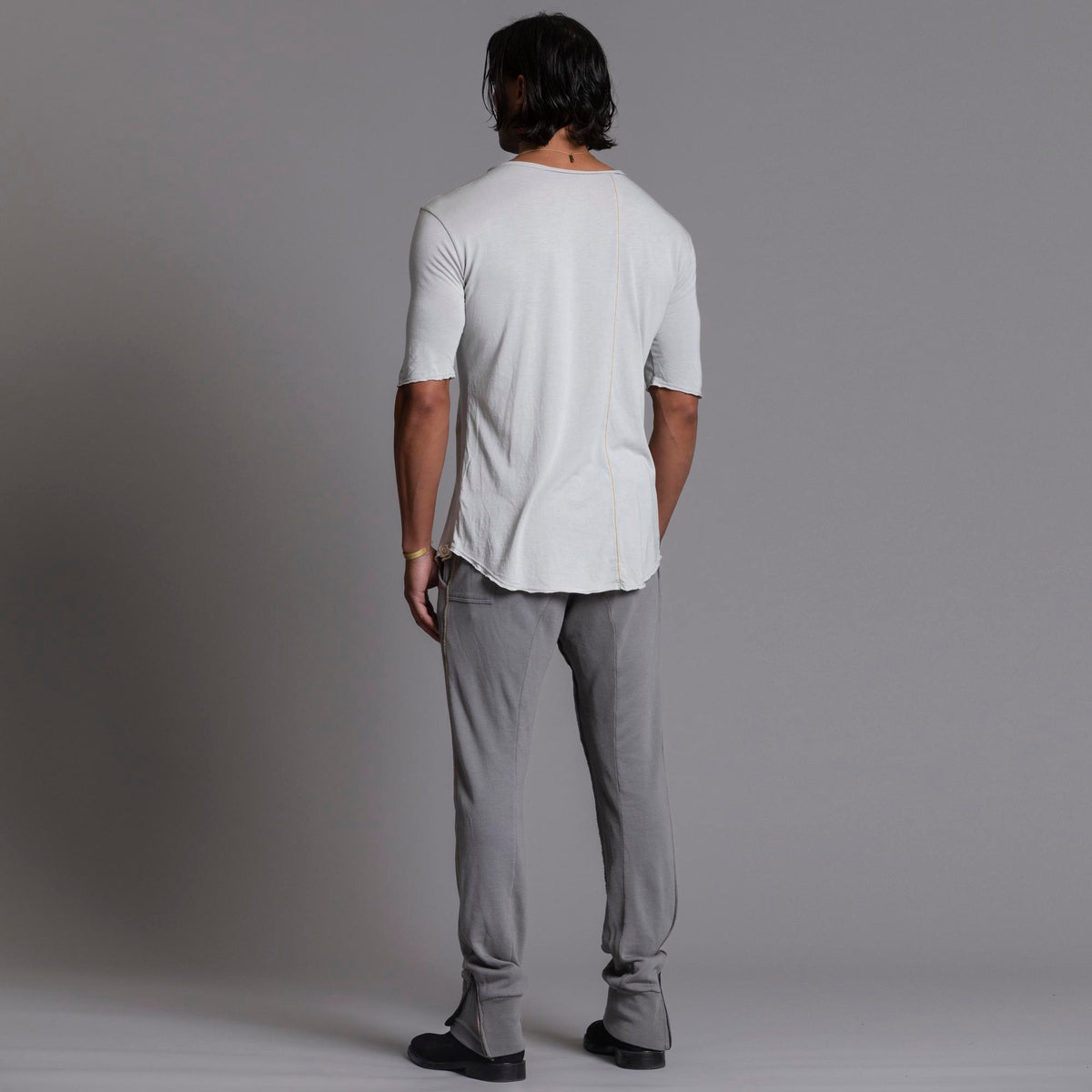Man modeling the milano pant in deep clay gray