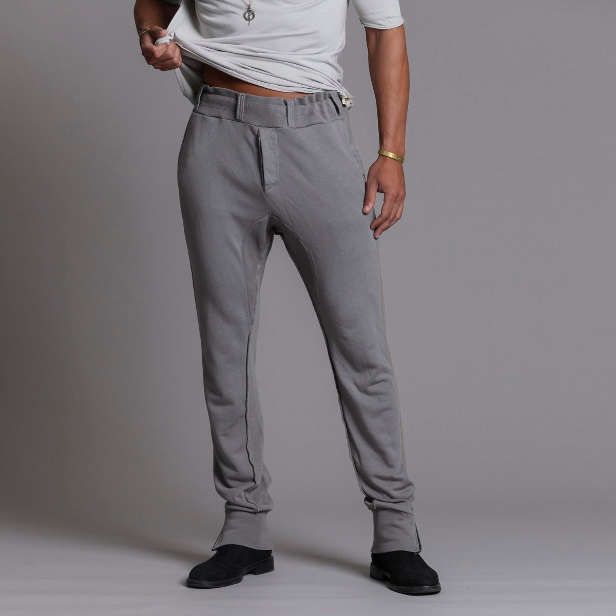 Man modeling the milano pant in deep clay gray