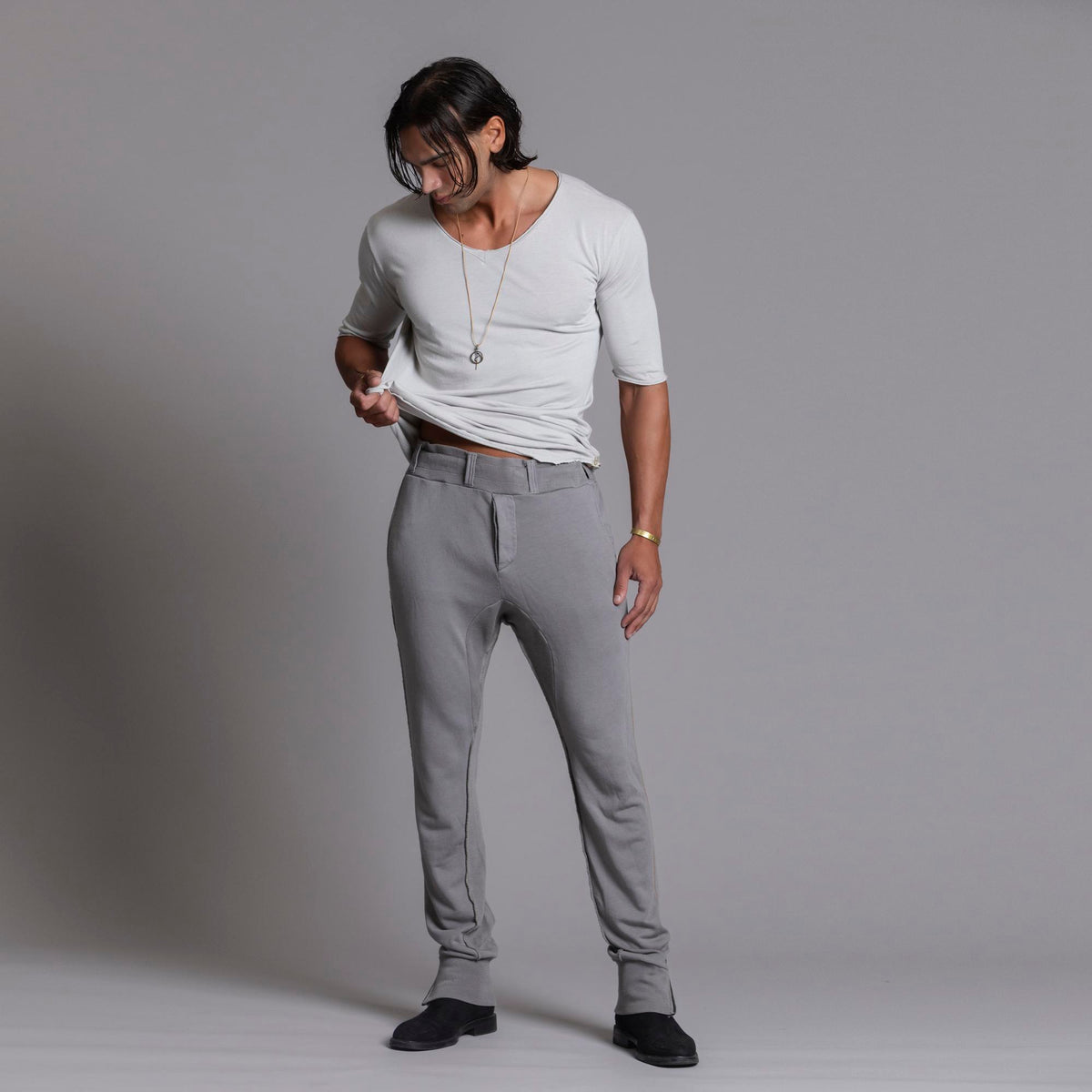 Man modeling the milano pant in deep clay gray
