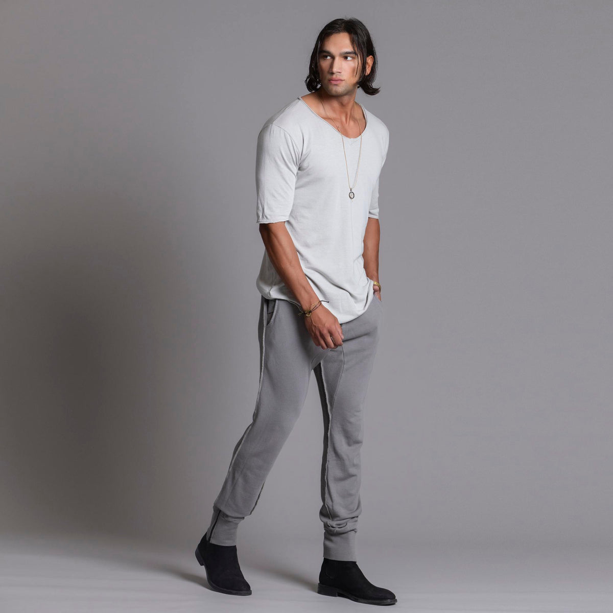 Man modeling the milano pant in deep clay gray