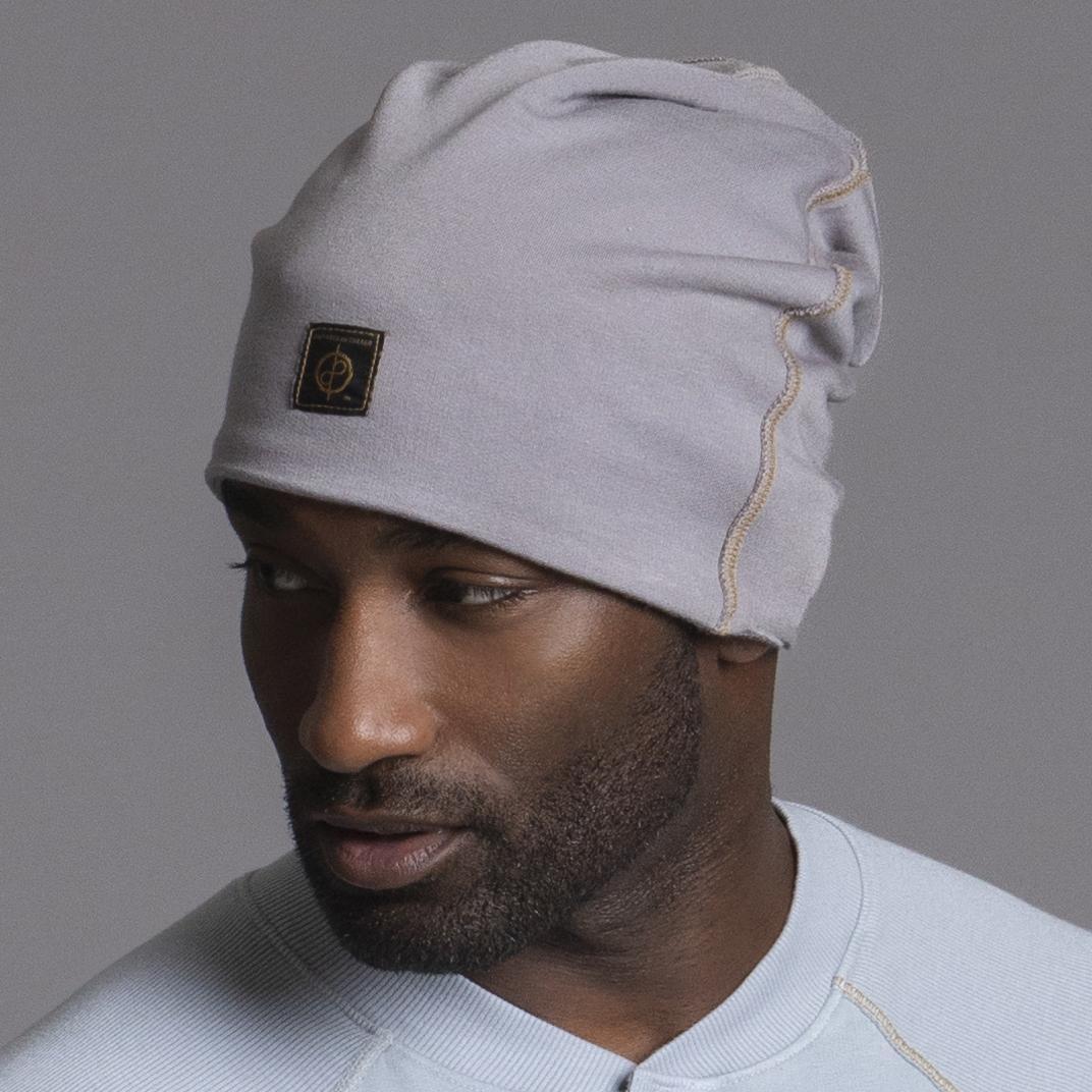 A man modeling the One Golden Thread OG Cloud Beanie in Shroom