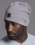 A man modeling the One Golden Thread OG Cloud Beanie in Shroom