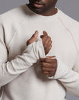 A man modeling a One Golden Thread Waffle Long Sleeve Raglan shirt in white stone
