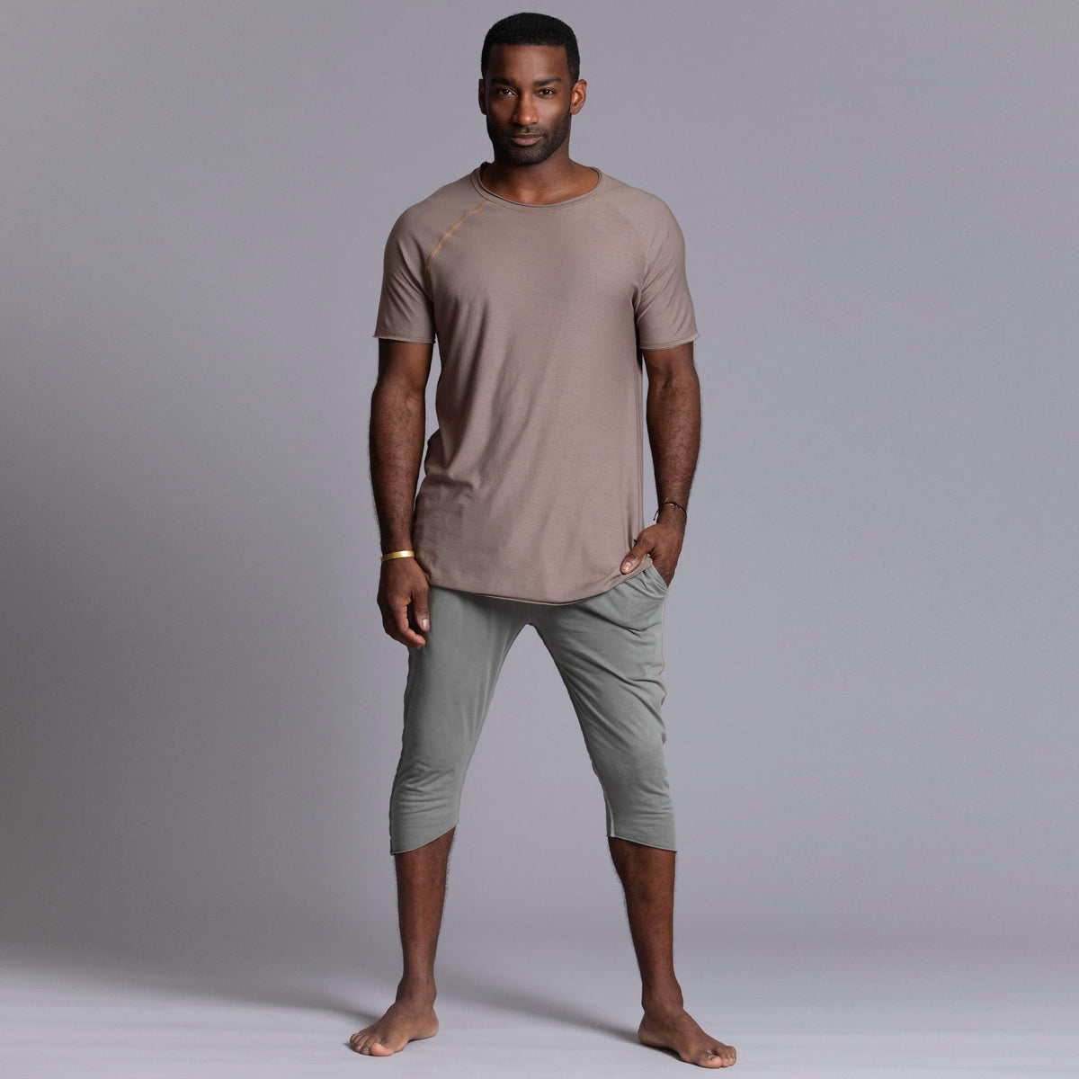 Male modeling Green Clay colored yogo mid shorts