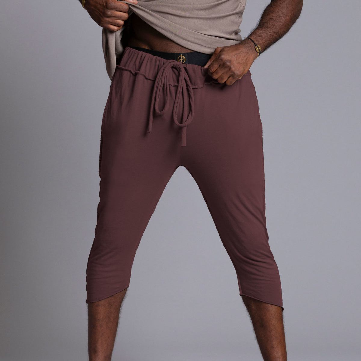 Male modeling yogo mid pants in brazen