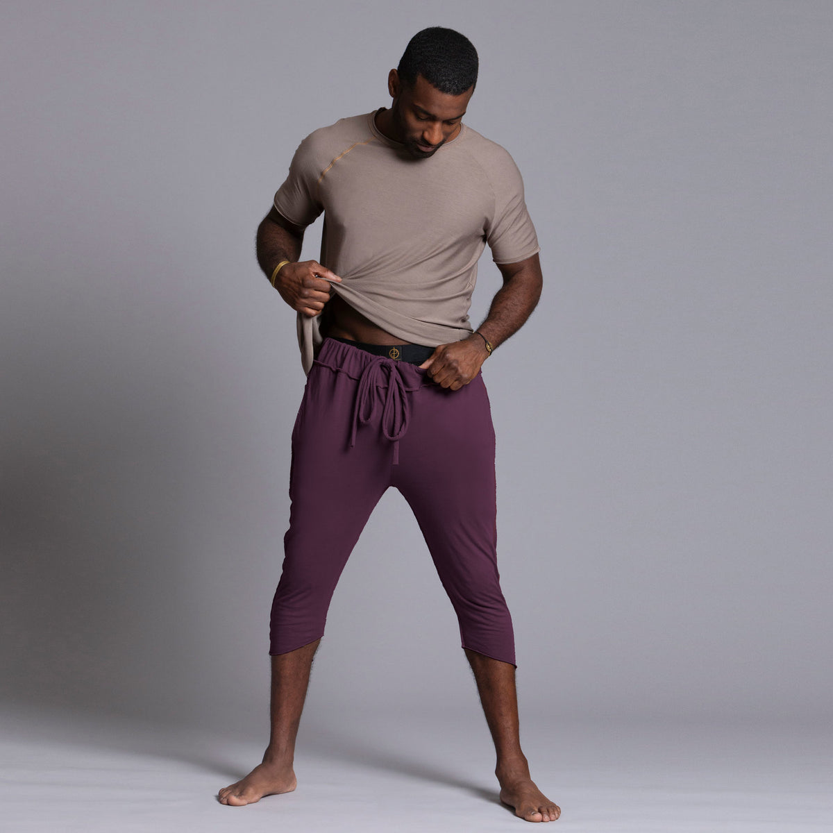 Male modeling Eggplant colored yogo mid pants