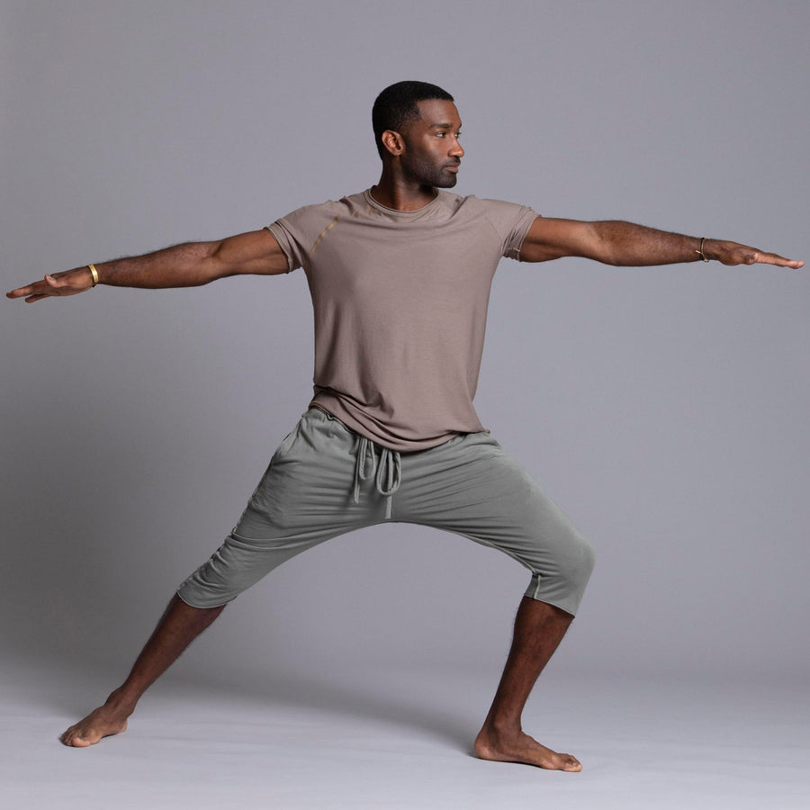 Male modeling Green Clay colored yogo mid shorts