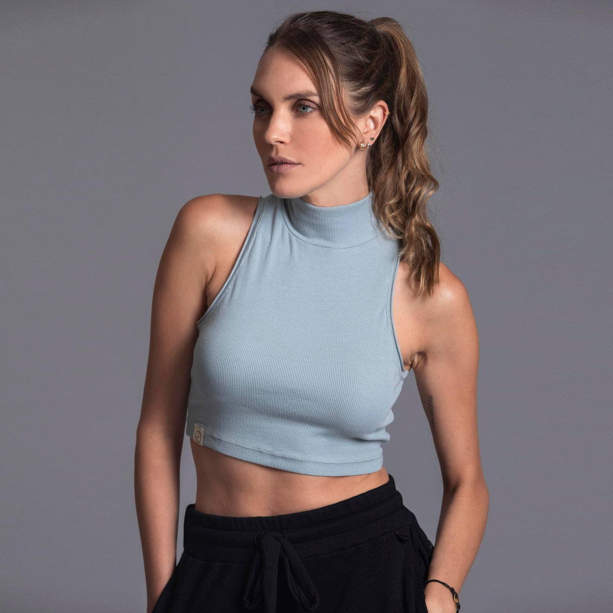 Woman modeling high neck crop in Agave