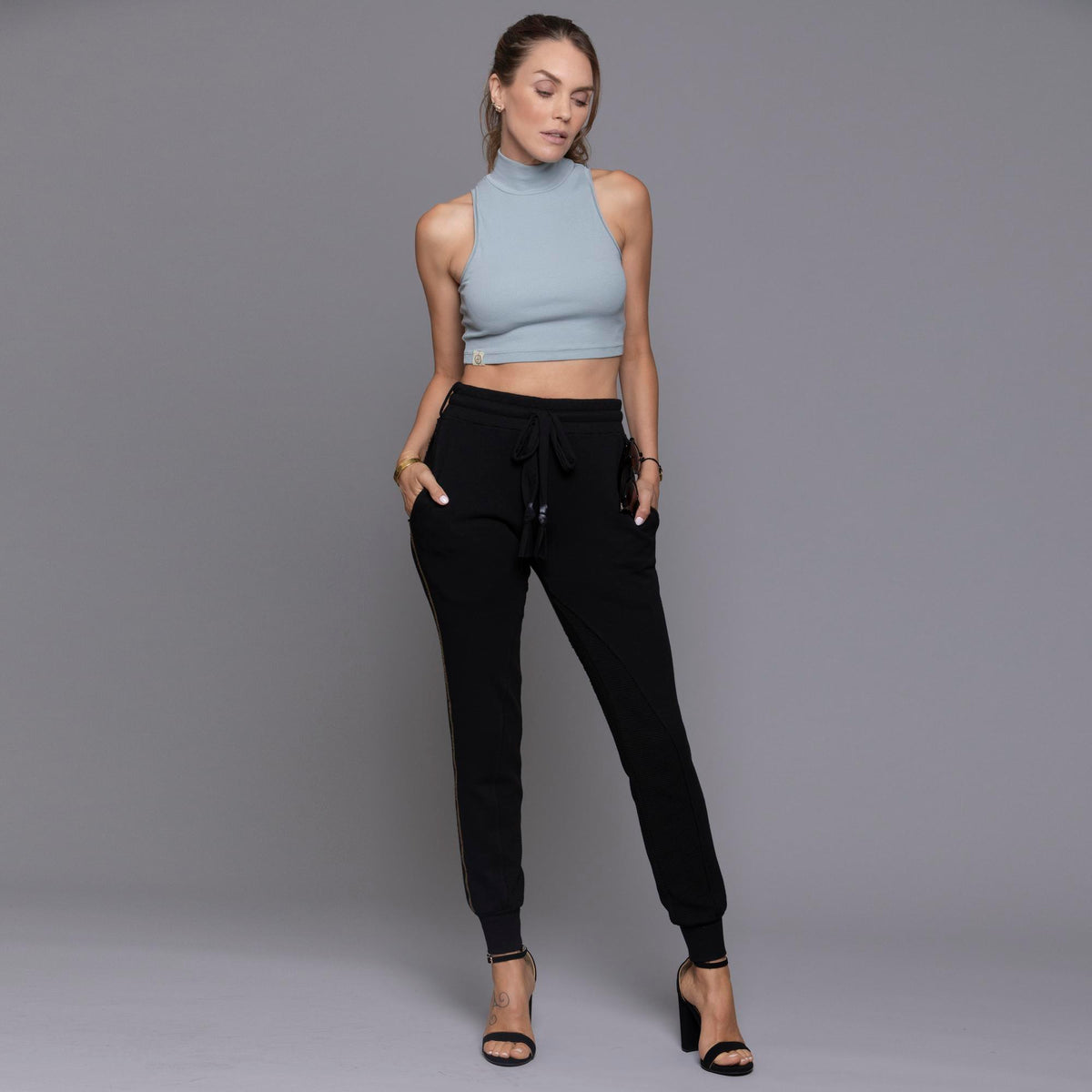A woman modeling the One Golden Thread Jogga Pants in Black