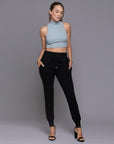 A woman modeling the One Golden Thread Jogga Pants in Black