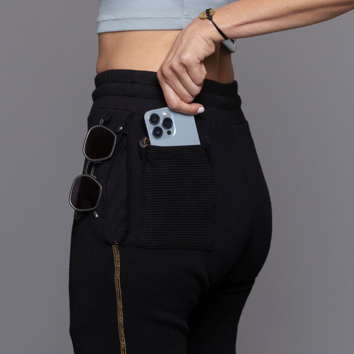 A woman modeling the One Golden Thread Jogga Pants in Black