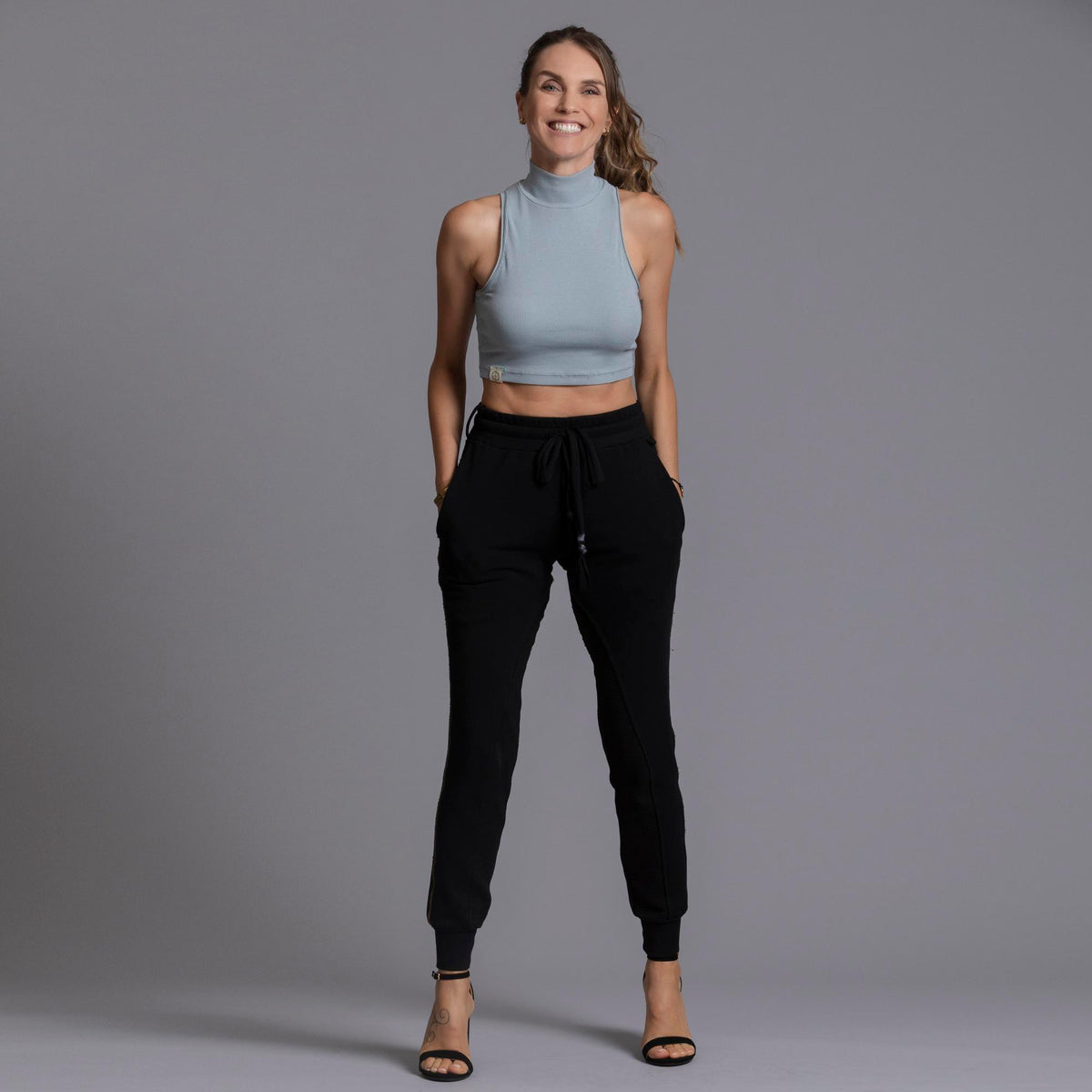 A woman modeling the One Golden Thread Jogga Pants in Black