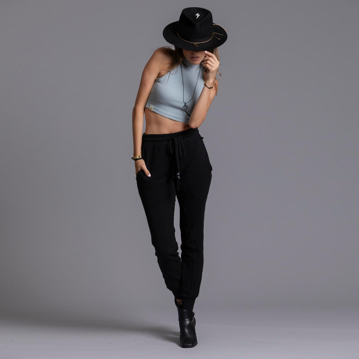 A woman modeling the One Golden Thread Jogga Pants in Black