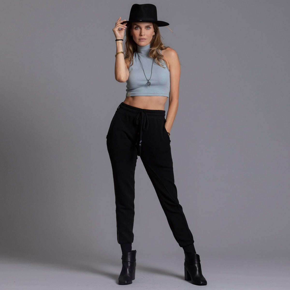A woman modeling the One Golden Thread Jogga Pants in Black