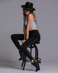 A woman modeling the One Golden Thread Jogga Pants in Black