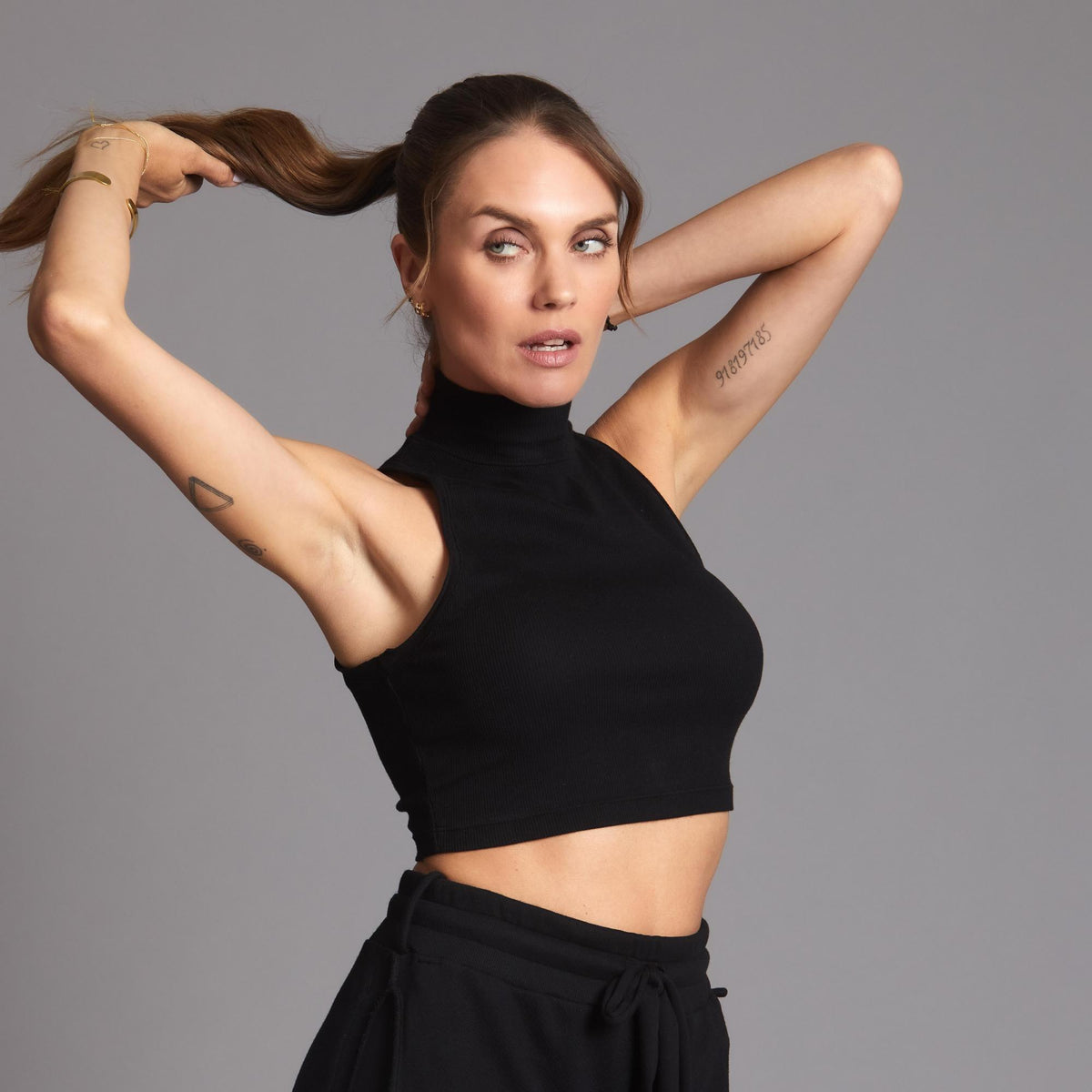 Woman modeling high neck crop in Black