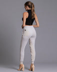 A woman modeling the One Golden Thread Jogga Pants in White Stone 