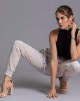 A woman modeling the One Golden Thread Jogga Pants in White Stone