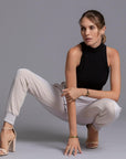 A woman modeling the One Golden Thread Jogga Pants in White Stone