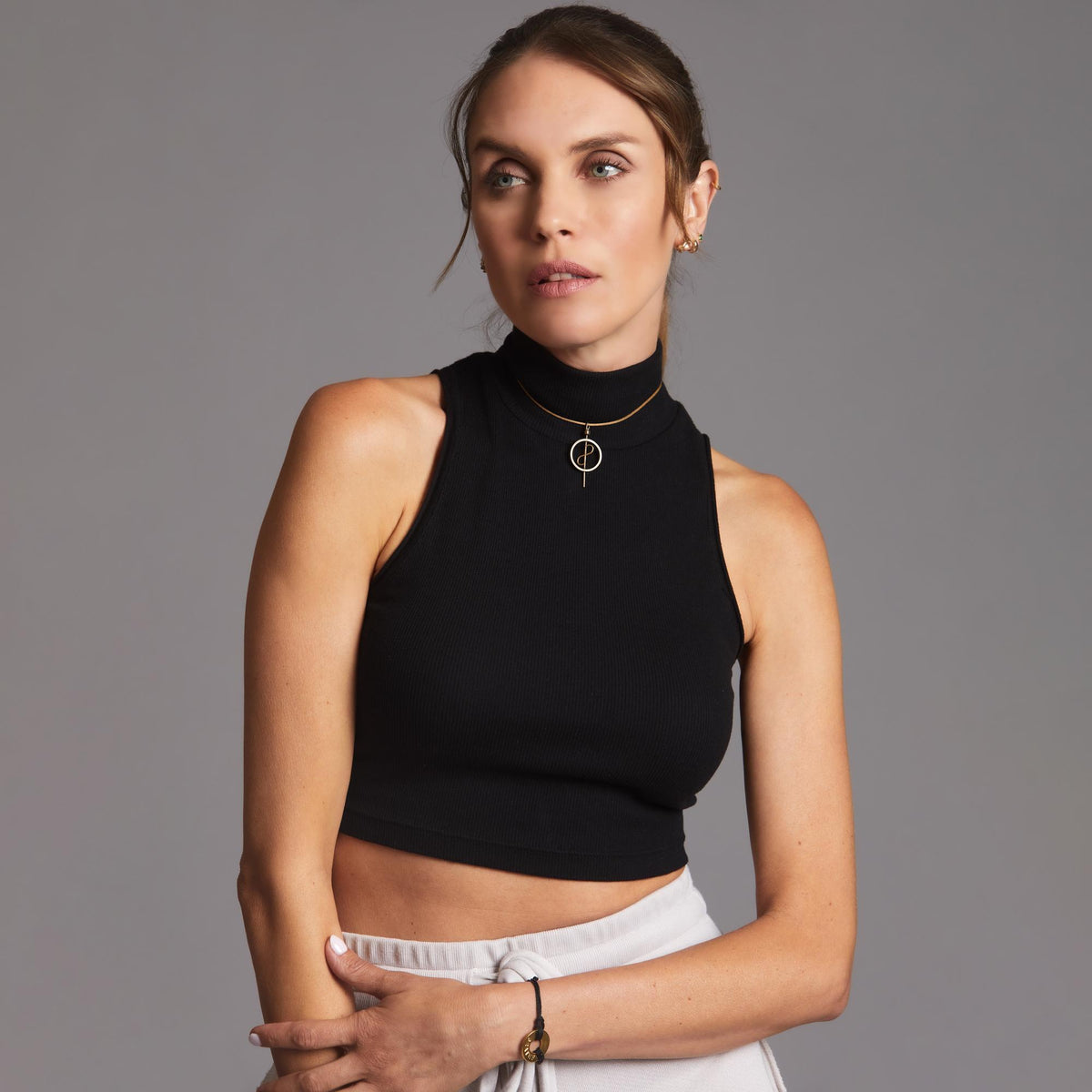 Woman modeling high neck crop in Black