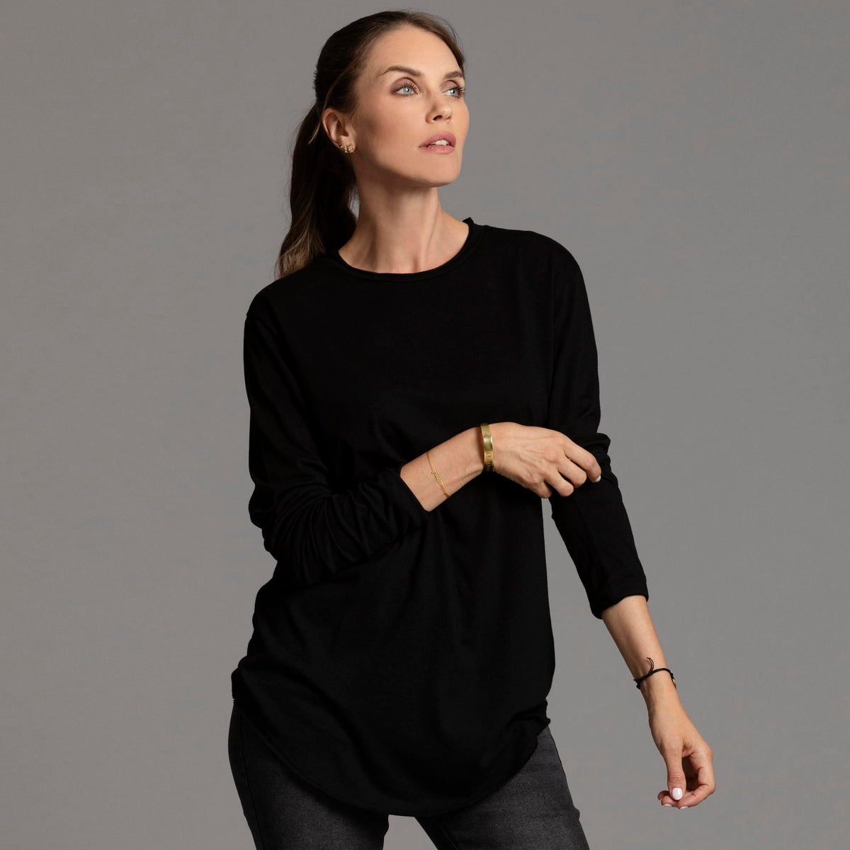 Woman modeling long sleeve crew shirt in black