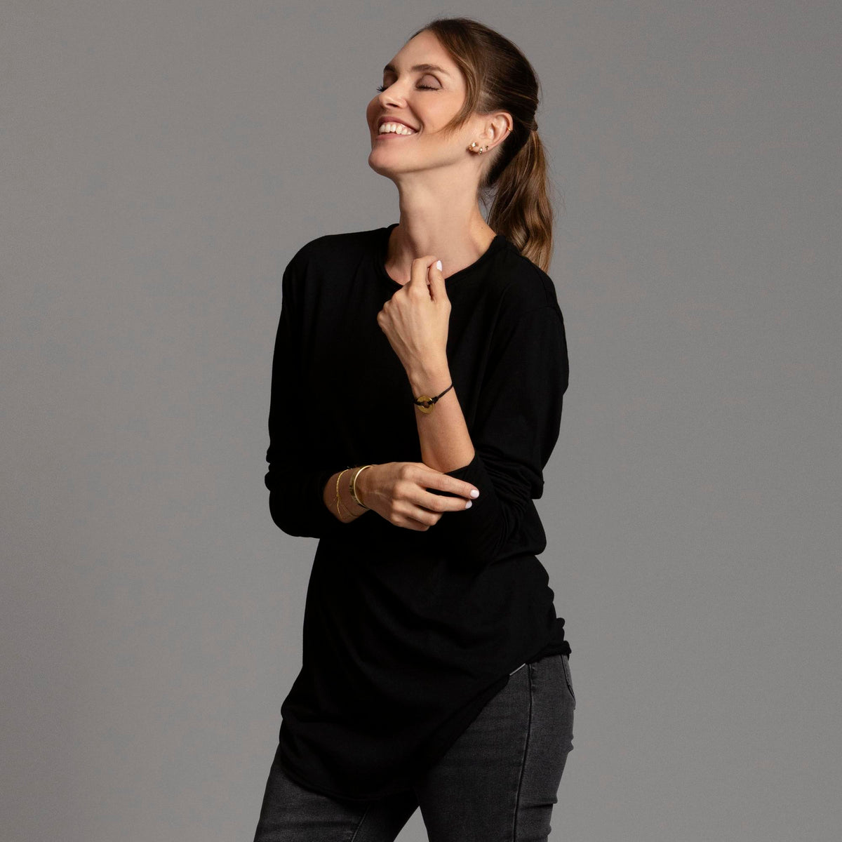 Woman modeling long sleeve crew shirt in black