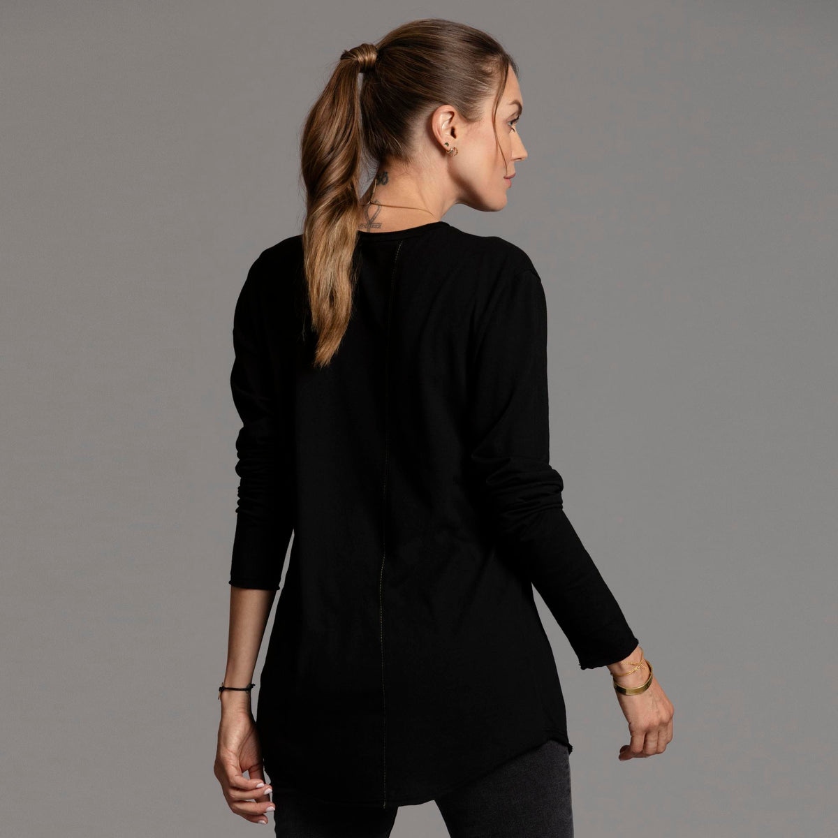 Woman modeling long sleeve crew shirt in black