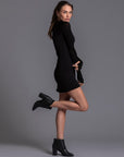 A woman modeling the One Golden Thread Reversible Little Black Dress